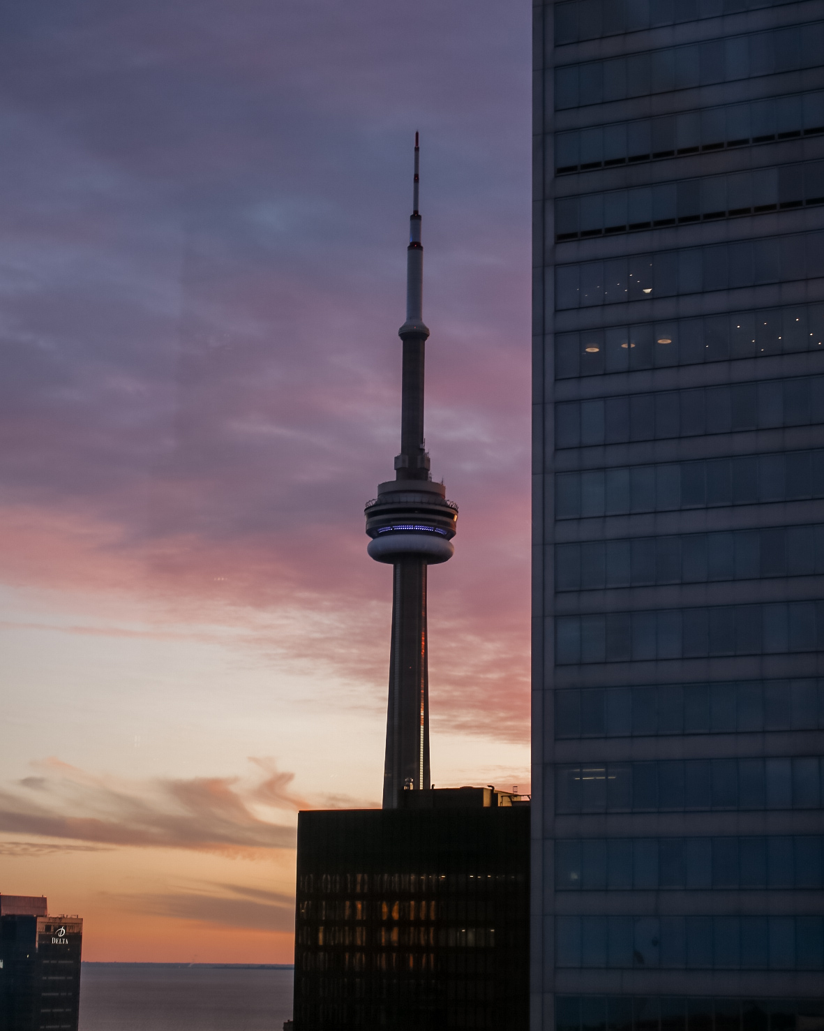 view of the cn tower at night from one king west